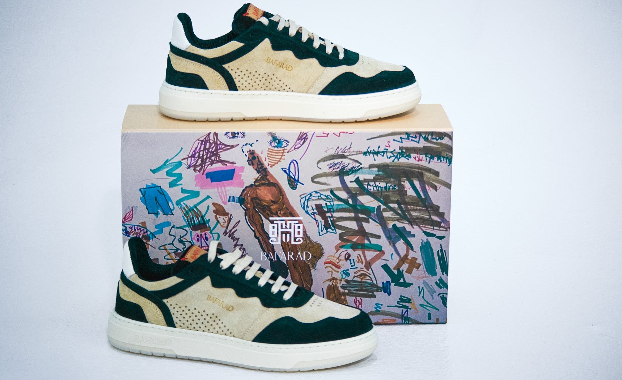 Pair of green and white sneakers on a colorful box with abstract designs.