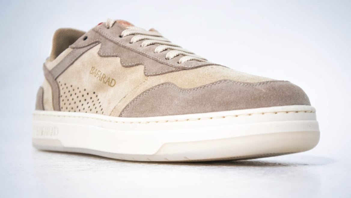 Beige sneaker with white sole on a light gray background