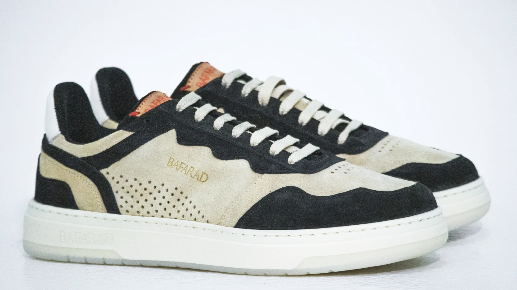Pair of black and white sneakers on a light gray background