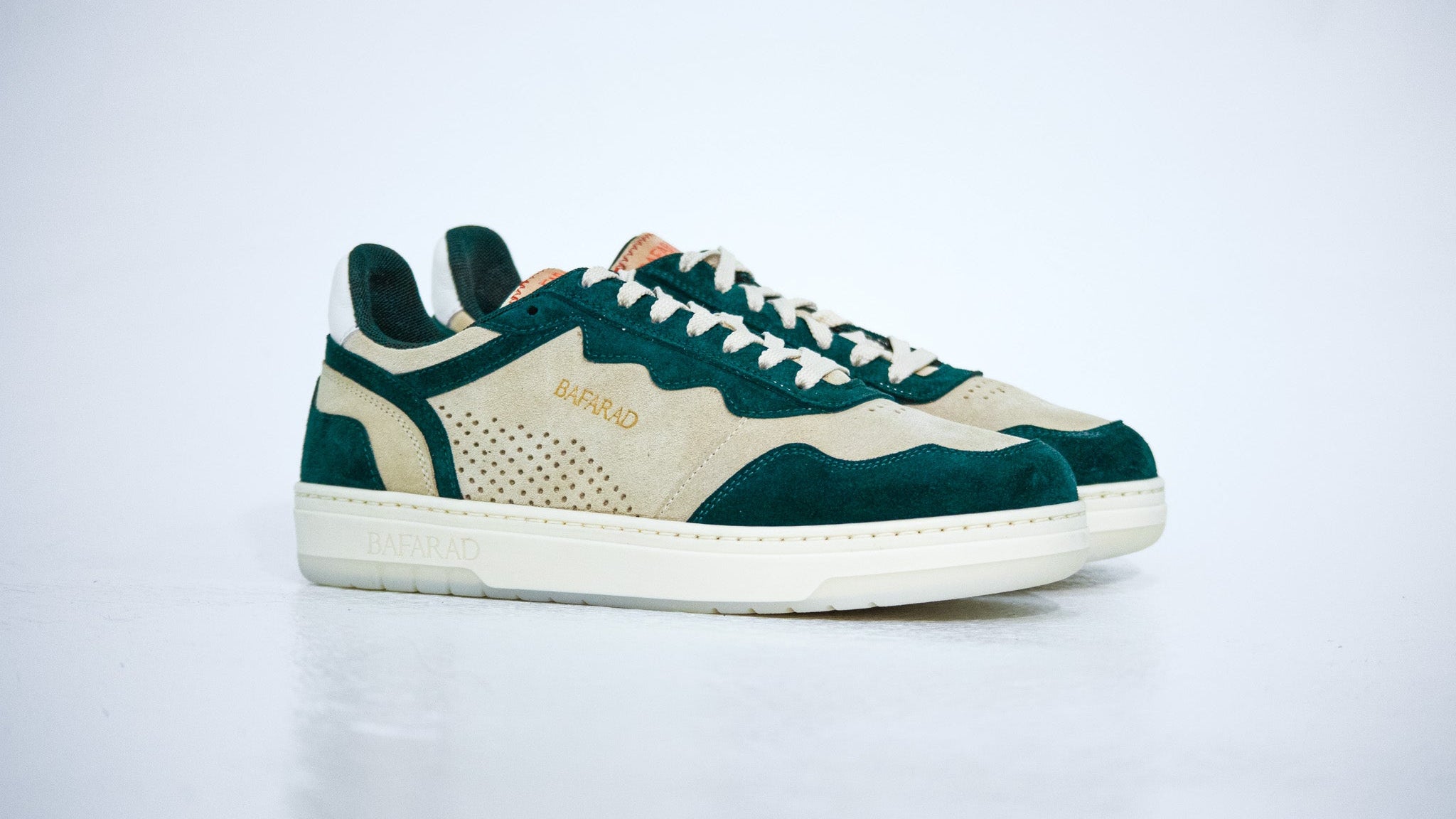 Green and beige sneaker on a light gray background