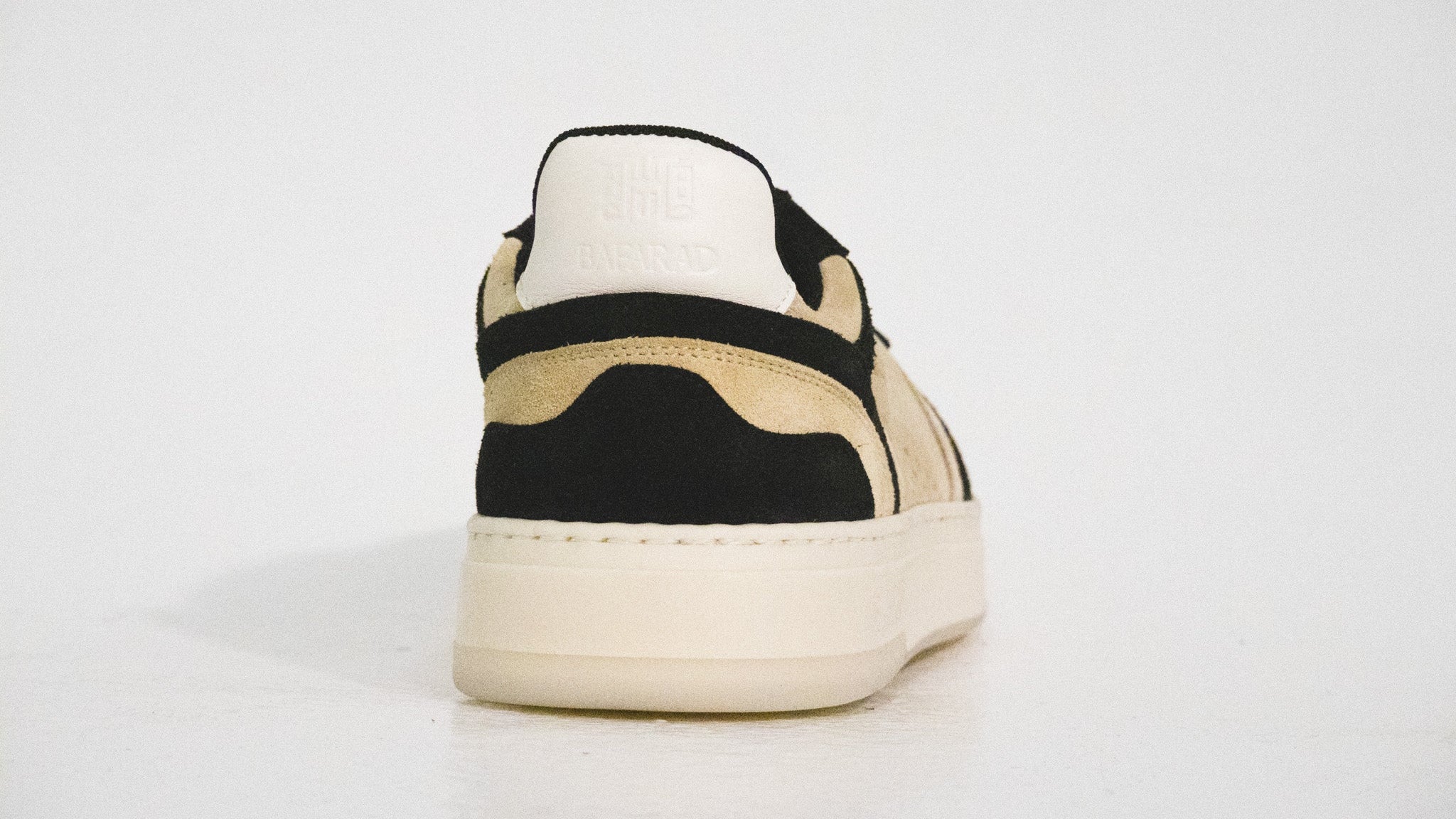 Black and beige sneaker on a white background